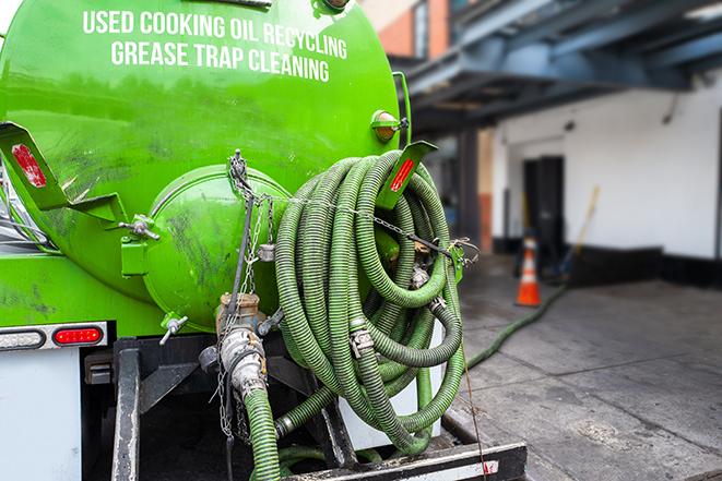 a vacuum truck pumping out a large underground grease trap in Dracut MA